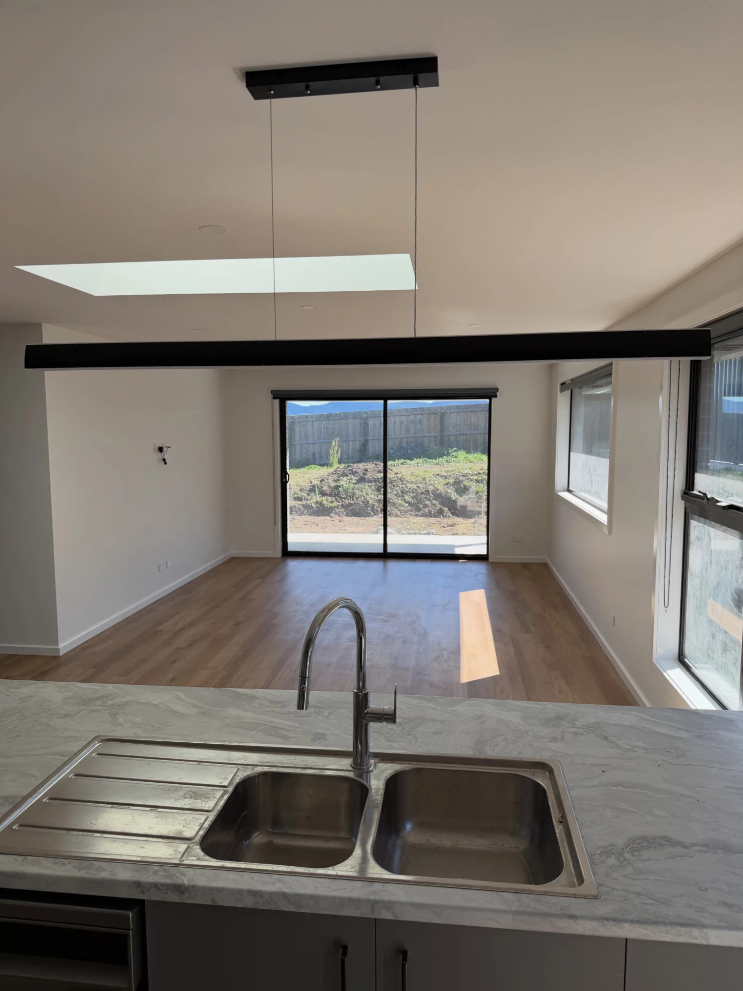 Kitchen looking through to a freshly painted living area